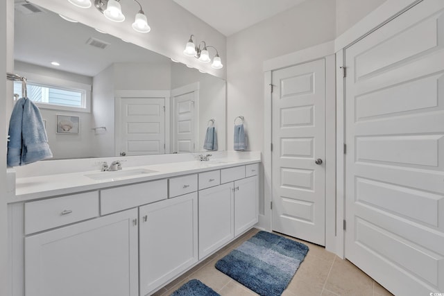 bathroom featuring tile patterned flooring and vanity