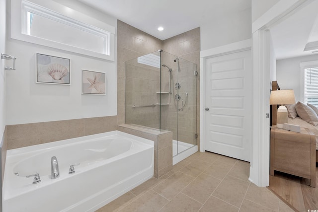 bathroom featuring tile patterned flooring and independent shower and bath