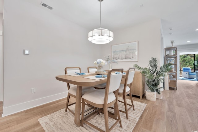 dining space with light wood-type flooring