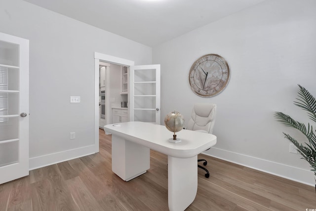 office with light hardwood / wood-style floors