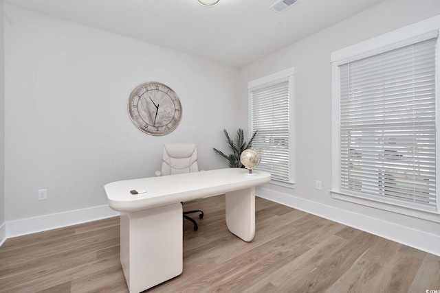 unfurnished office featuring light wood-type flooring