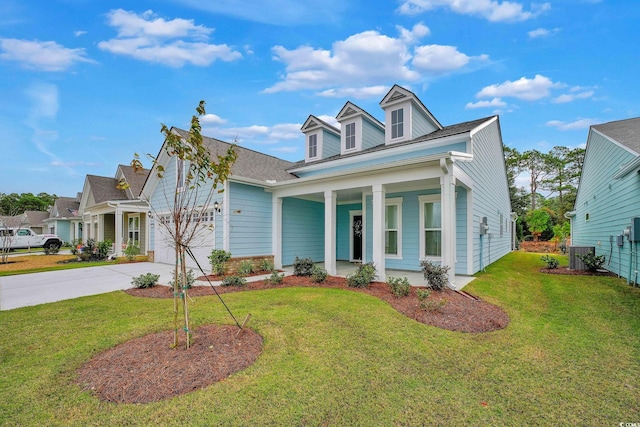 view of front of home featuring a porch, a front yard, and a garage