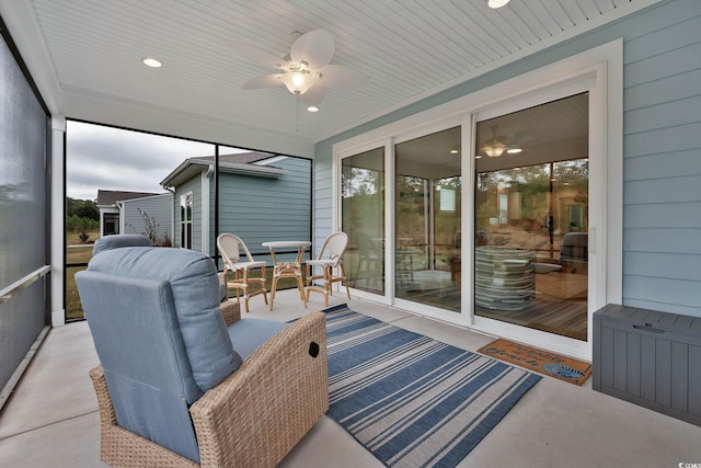 sunroom / solarium featuring ceiling fan and wood ceiling