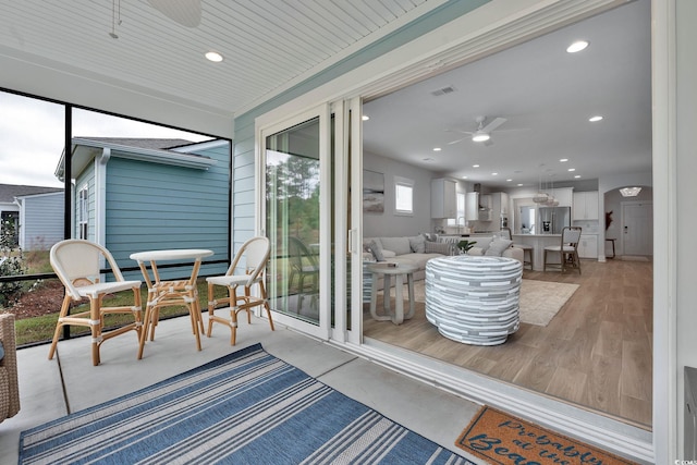 sunroom / solarium with ceiling fan and wooden ceiling