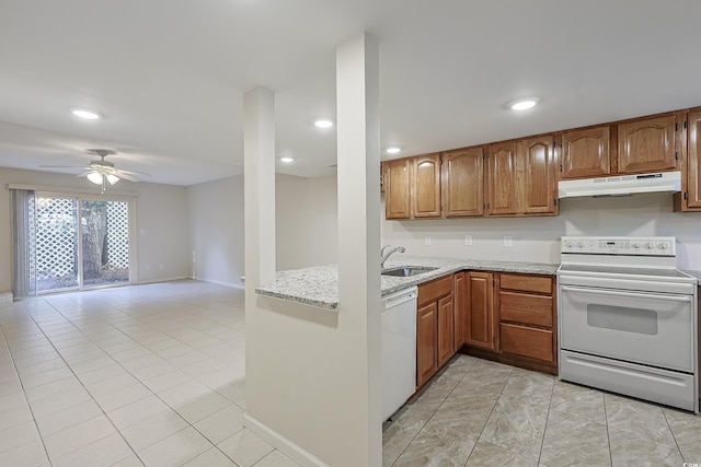 kitchen featuring sink, light stone counters, light tile patterned floors, ceiling fan, and white appliances