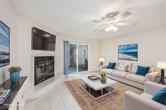 tiled living room with ceiling fan and a fireplace