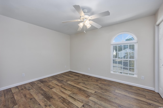 empty room with dark wood-type flooring and ceiling fan