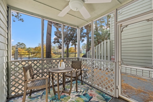 unfurnished sunroom featuring ceiling fan