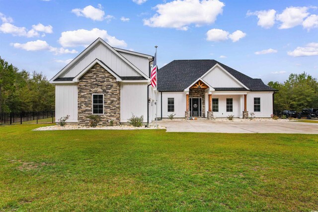 modern farmhouse style home featuring a porch and a front yard