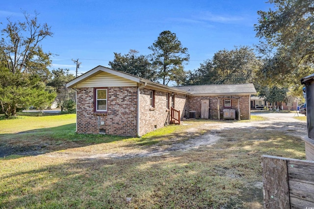 view of property exterior with central AC and a yard