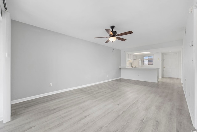 unfurnished living room with ceiling fan and light hardwood / wood-style flooring