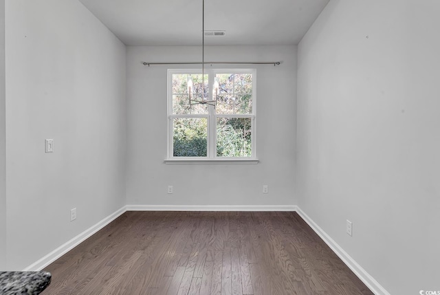 spare room featuring dark hardwood / wood-style flooring