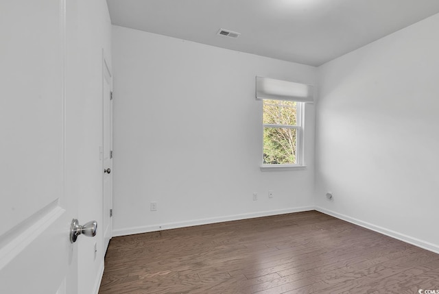 empty room featuring dark hardwood / wood-style flooring