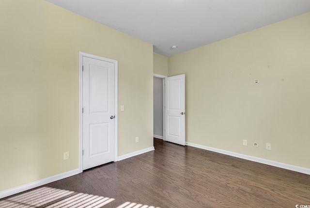 unfurnished bedroom with dark hardwood / wood-style flooring