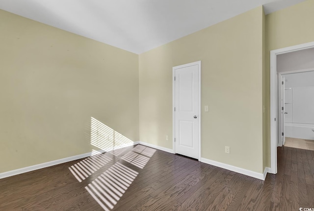 spare room with dark wood-type flooring