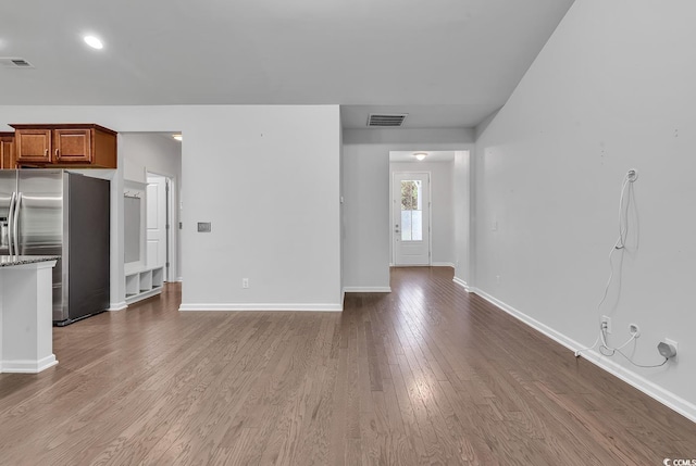 unfurnished living room featuring hardwood / wood-style flooring