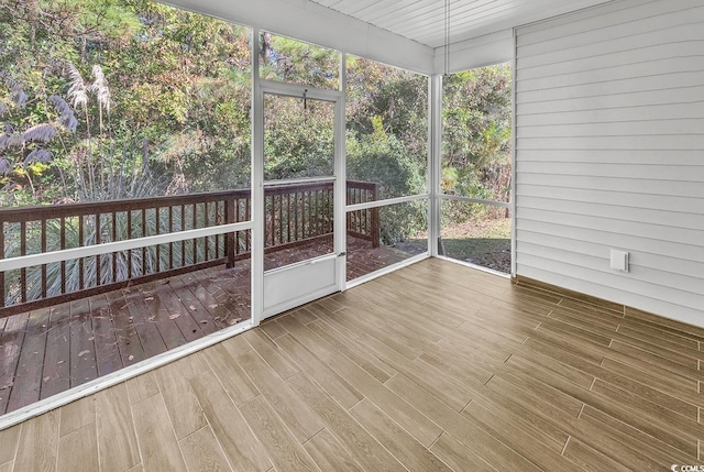 unfurnished sunroom with plenty of natural light