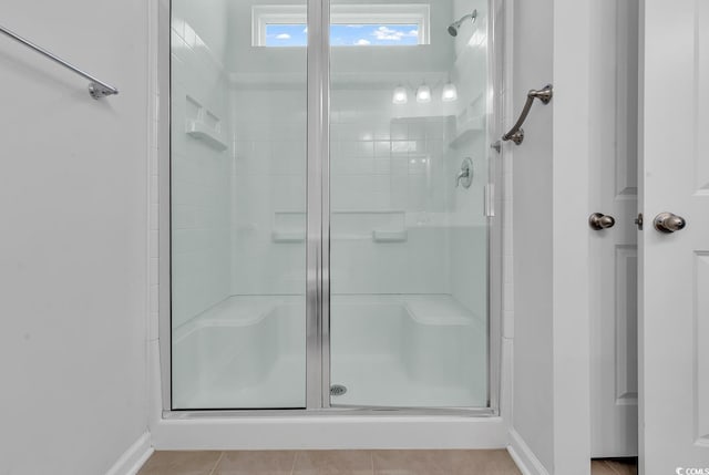 bathroom with tile patterned floors and an enclosed shower