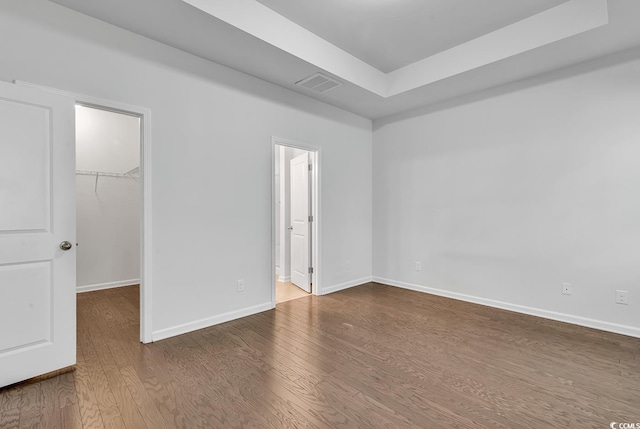 unfurnished room with wood-type flooring