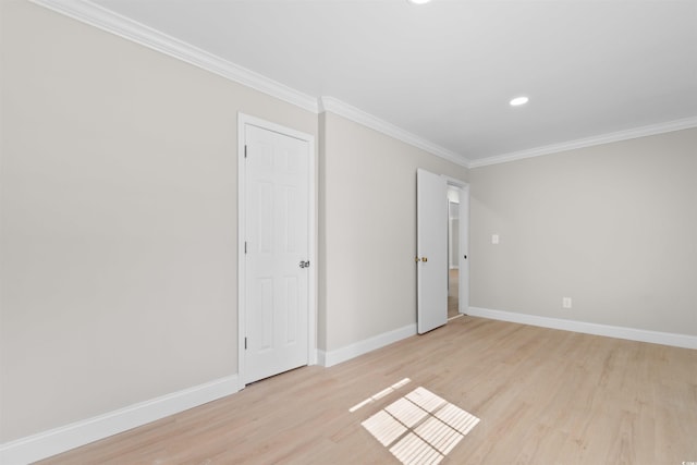 spare room featuring light hardwood / wood-style flooring and ornamental molding