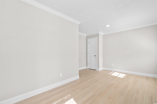 empty room with light wood-type flooring and ornamental molding