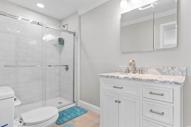 bathroom with toilet, vanity, a shower with door, and hardwood / wood-style flooring