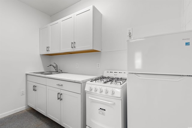 kitchen featuring white appliances, white cabinetry, and sink