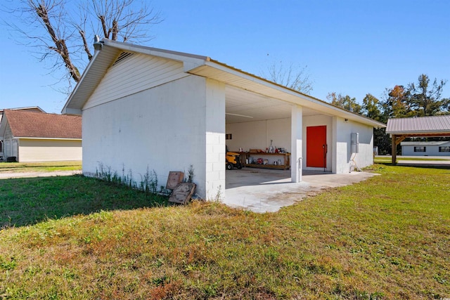 view of side of home with a yard