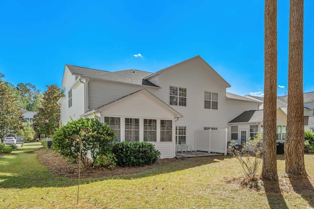 rear view of property with a lawn