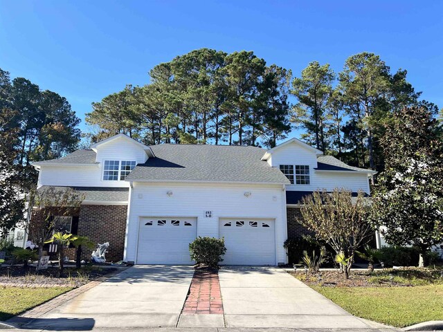 493 Shellbank Dr Unit 2-B, Longs, SC 29568 - traditional-style home featuring a garage, driveway, brick siding, and roof with shingles
