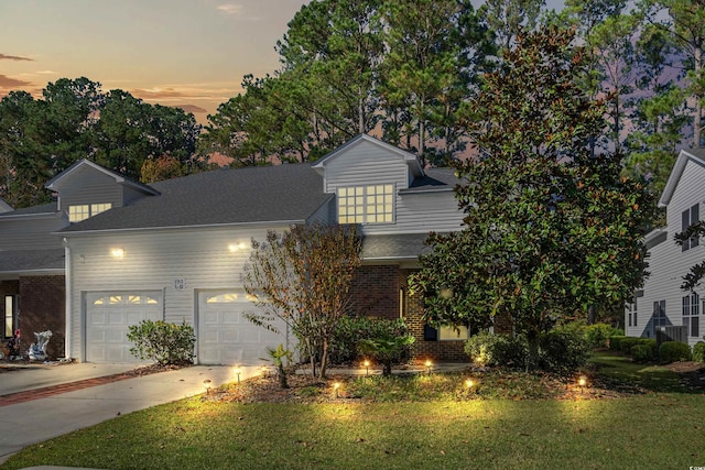 view of front facade with a lawn and a garage