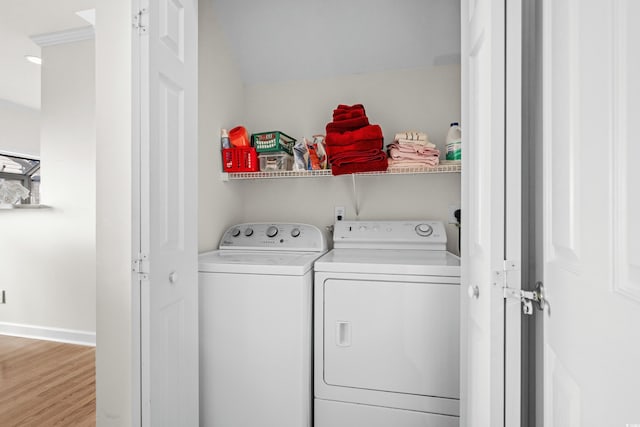 laundry area with hardwood / wood-style floors and independent washer and dryer