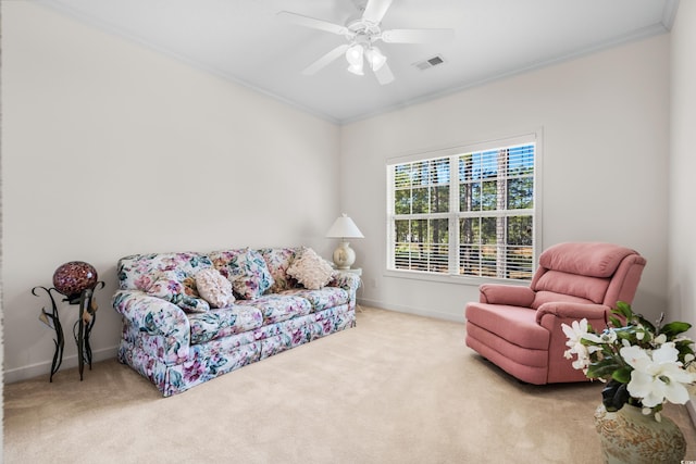 carpeted living room with crown molding and ceiling fan