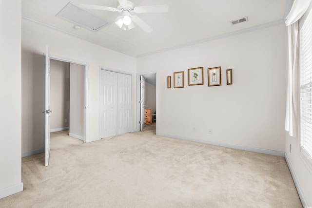 unfurnished bedroom featuring ceiling fan, light colored carpet, ornamental molding, and multiple windows