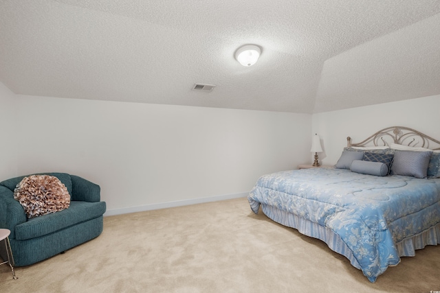 bedroom featuring lofted ceiling, carpet, and a textured ceiling