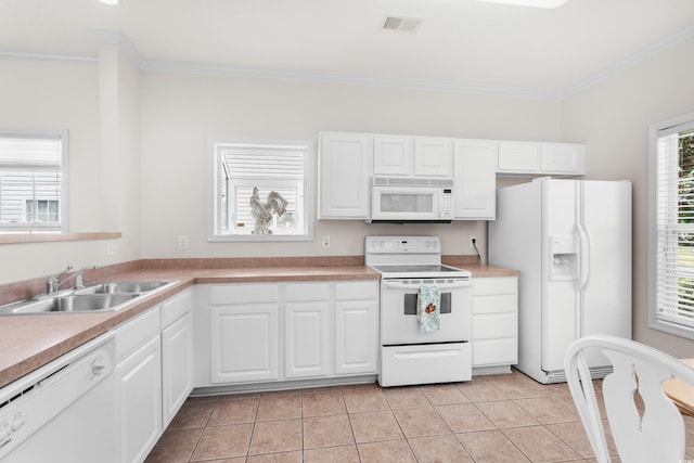 kitchen featuring sink, white cabinets, white appliances, light tile patterned floors, and ornamental molding