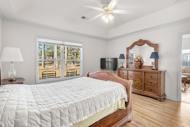 bedroom featuring ceiling fan, crown molding, and light wood-type flooring