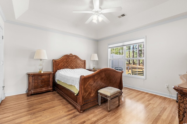 bedroom with ceiling fan, crown molding, and light wood-type flooring