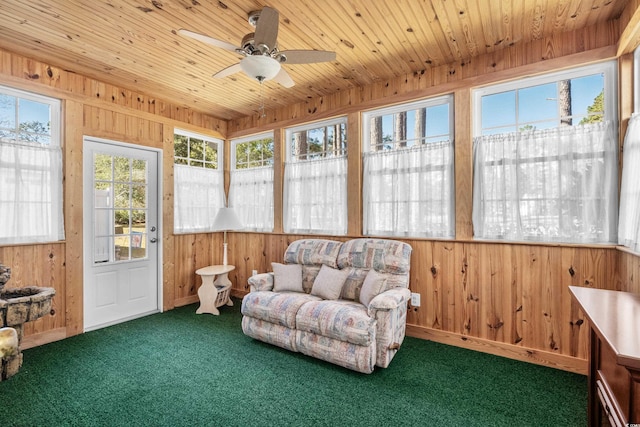 sunroom / solarium featuring ceiling fan and wood ceiling