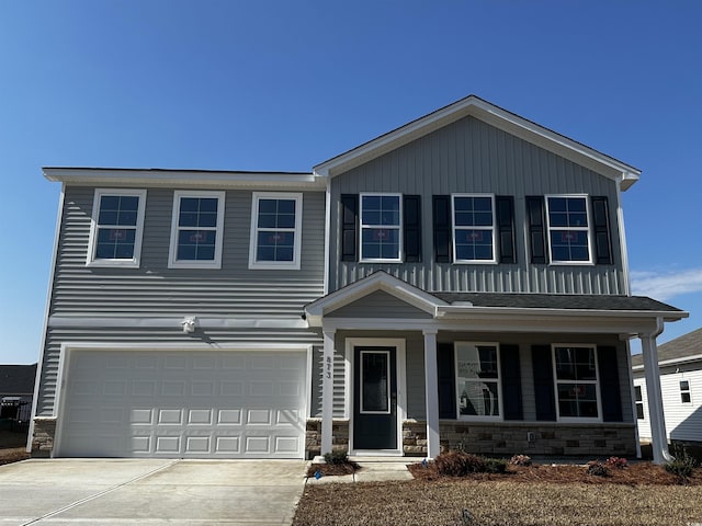 view of front of property featuring a garage and covered porch