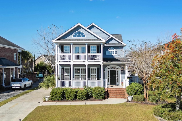 view of front of home featuring covered porch and a front yard