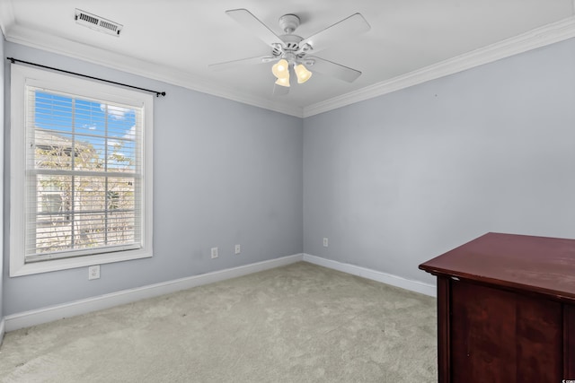 unfurnished room featuring light carpet, ceiling fan, and crown molding