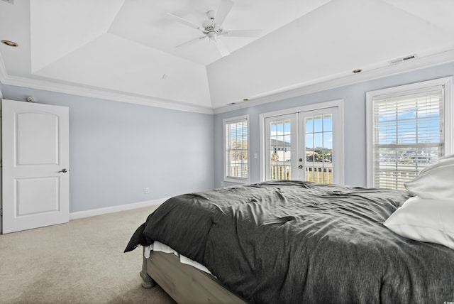 carpeted bedroom with ceiling fan, french doors, a tray ceiling, access to outside, and ornamental molding