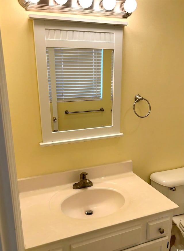 bathroom featuring vanity and toilet