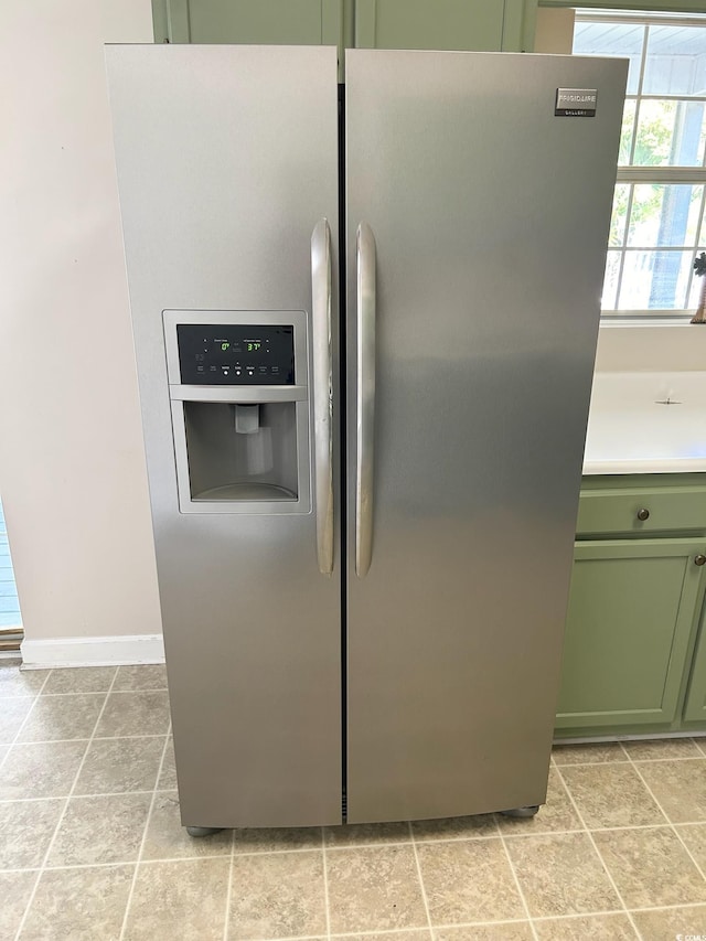 details with stainless steel fridge with ice dispenser and green cabinetry