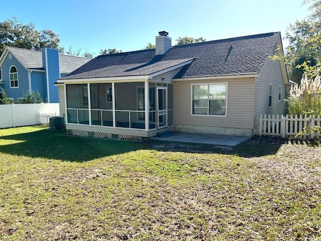 back of property with a patio area and a lawn