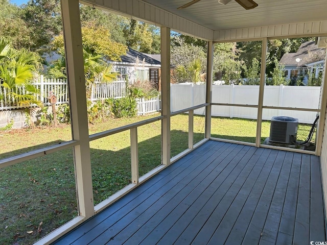 unfurnished sunroom featuring ceiling fan and a healthy amount of sunlight