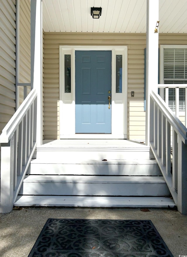 view of exterior entry featuring a porch