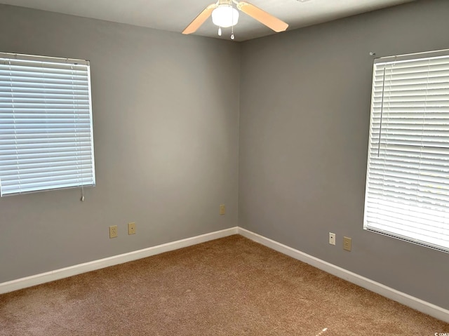 spare room featuring carpet and ceiling fan