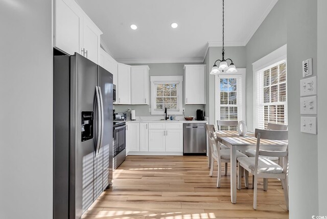 6001-1778 S Kings Hwy, Myrtle Beach, SC 29575 - kitchen featuring sink, decorative light fixtures, ornamental molding, stainless steel appliances, and white cabinets